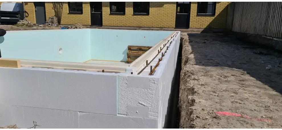 Vit isolerad betongvägg med ljusblå foder i Thermopool Standard